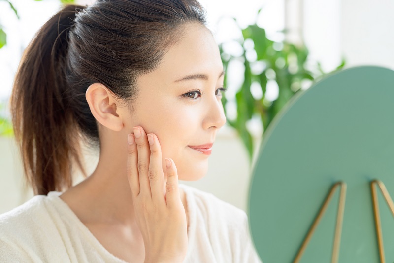 asian lady looking at mirror